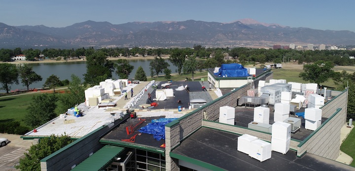 Work being done on the flat roof of a commercial building, Aerial drone shot by American Video Documentation.